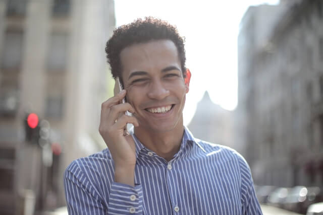 Man in businesses attire, outside talking on cell phone