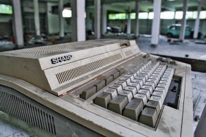 Old "Sharp" computer keyboard abandoned in a parking garage