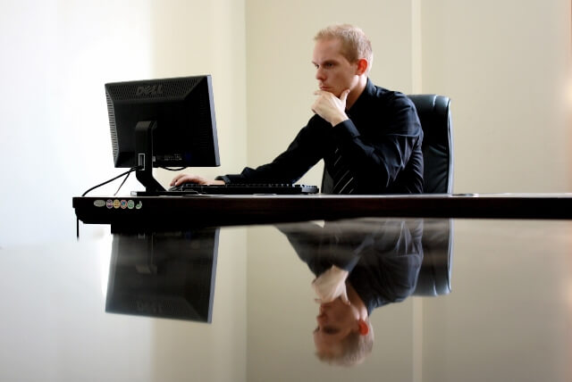 Man looking intently at his computer monitor