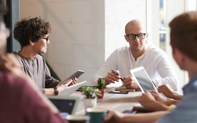 Business employees meeting to discuss year-end technology infrastructure review