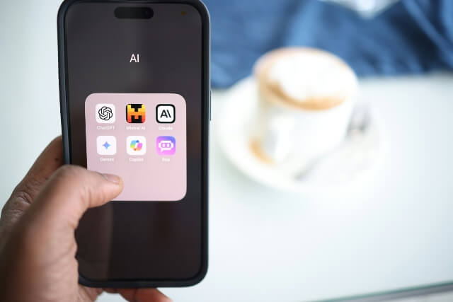 Smartphone showing several different free and paid AI apps