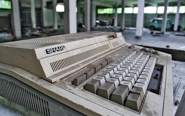 Old "Sharp" computer keyboard abandoned in a parking garage