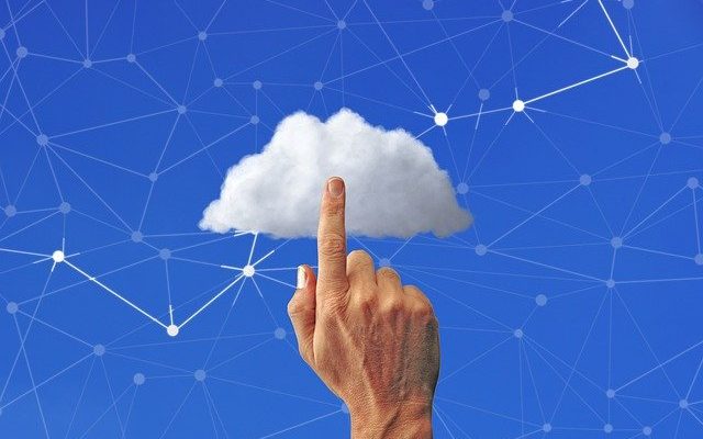 Finger touching cloud, lines in sky indicating networking