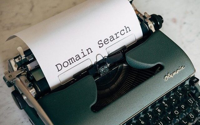Typewriter with a paper that says "Domain Search"
