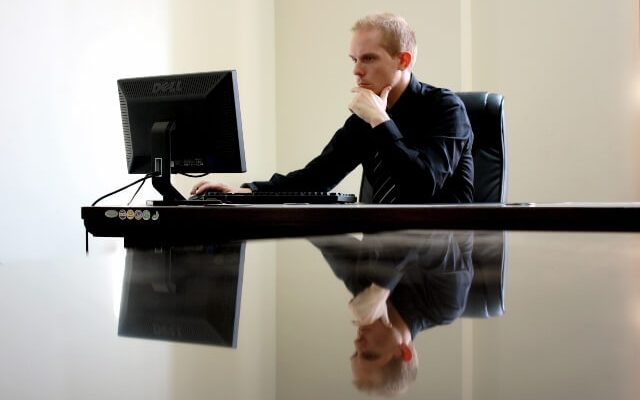 Man looking intently at his computer monitor